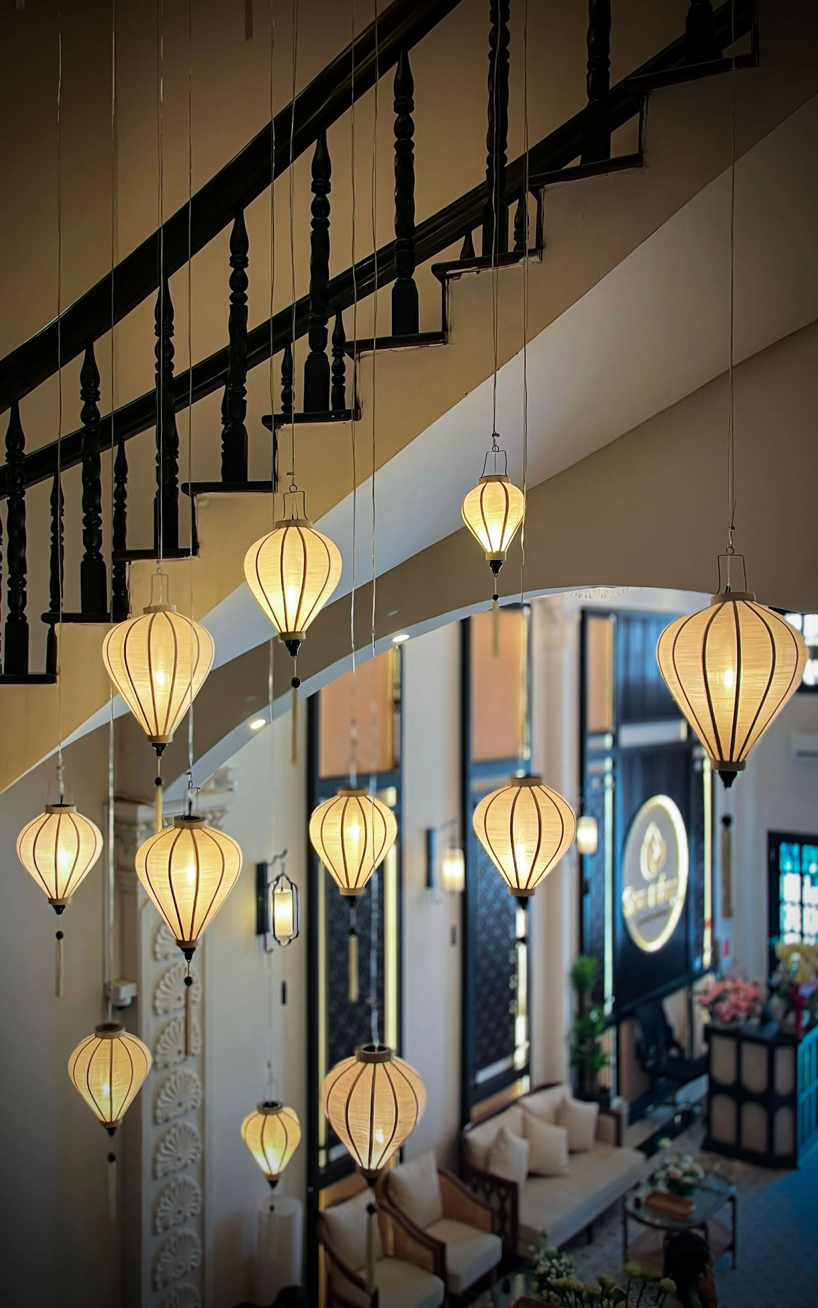 Glowing sculptural lanterns illuminate an architectural interior