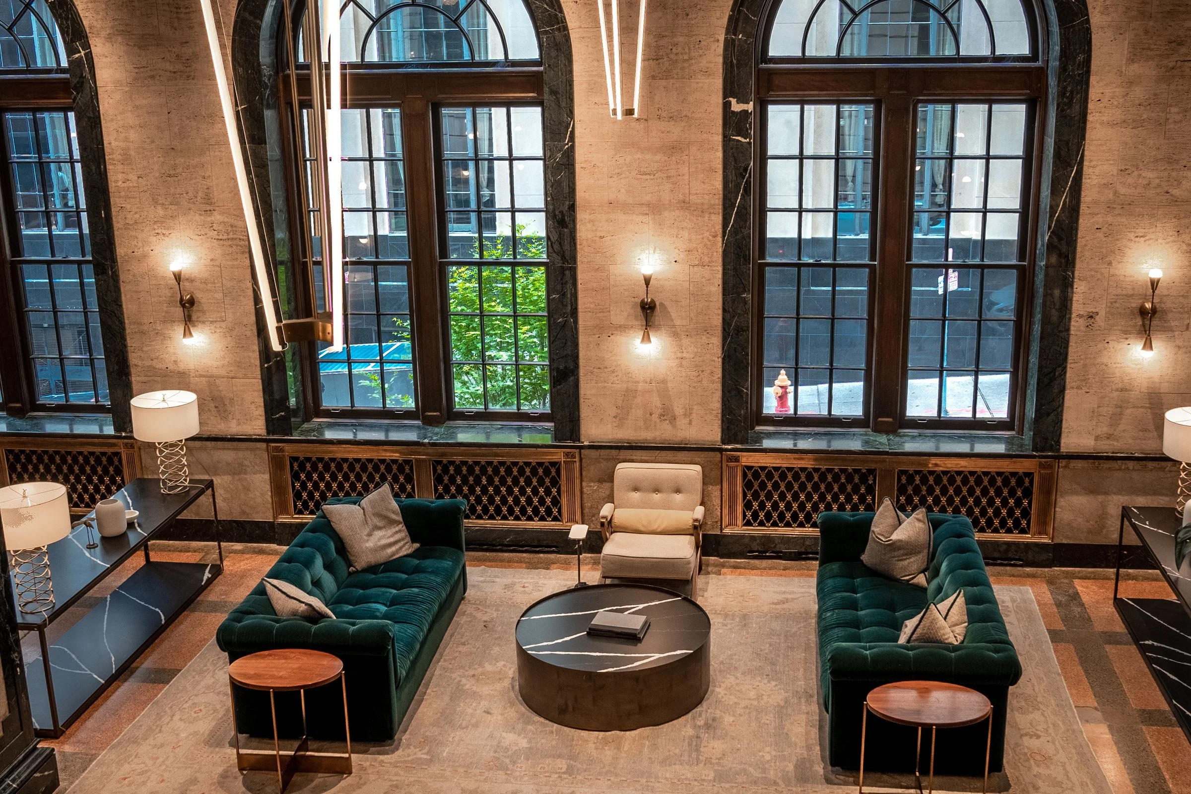 Layered wall and decorative lighting in a refined hospitality interior